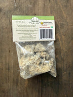 Bag of resin with a label on a wooden surface