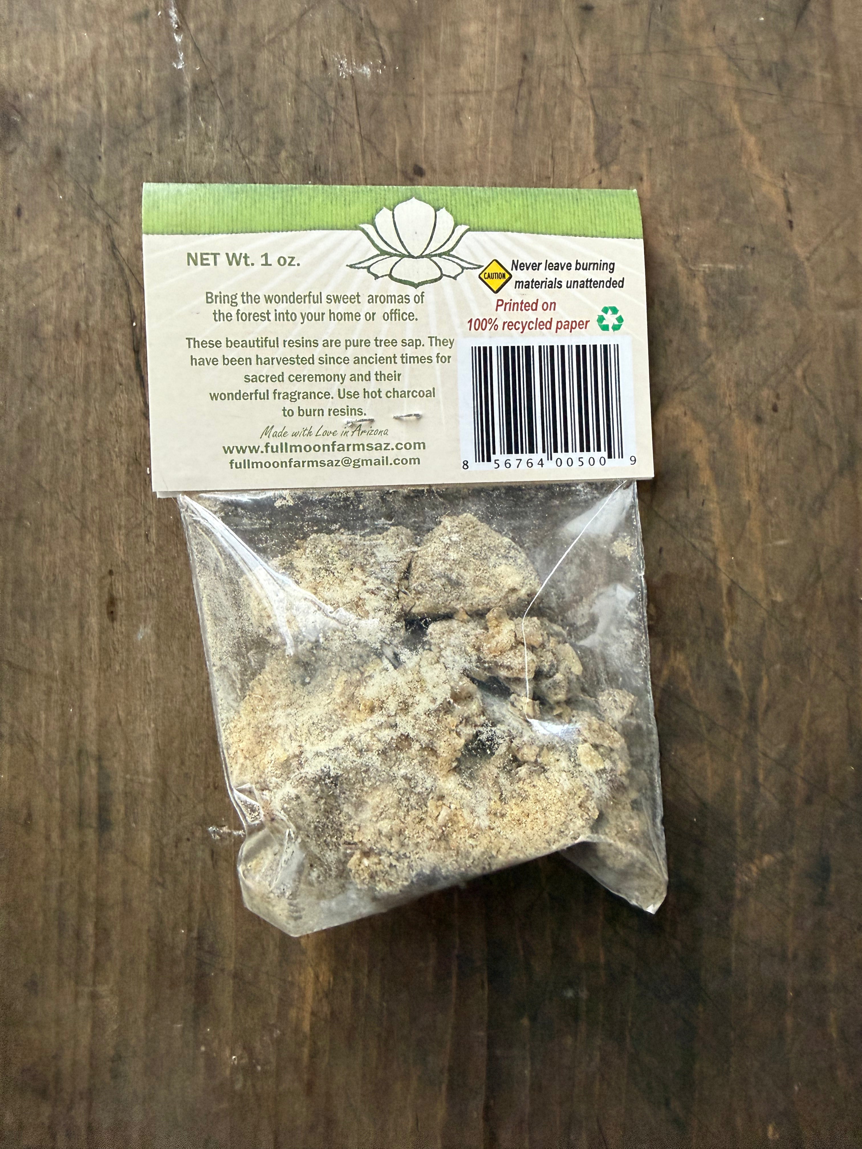 Bag of resin with a label on a wooden surface