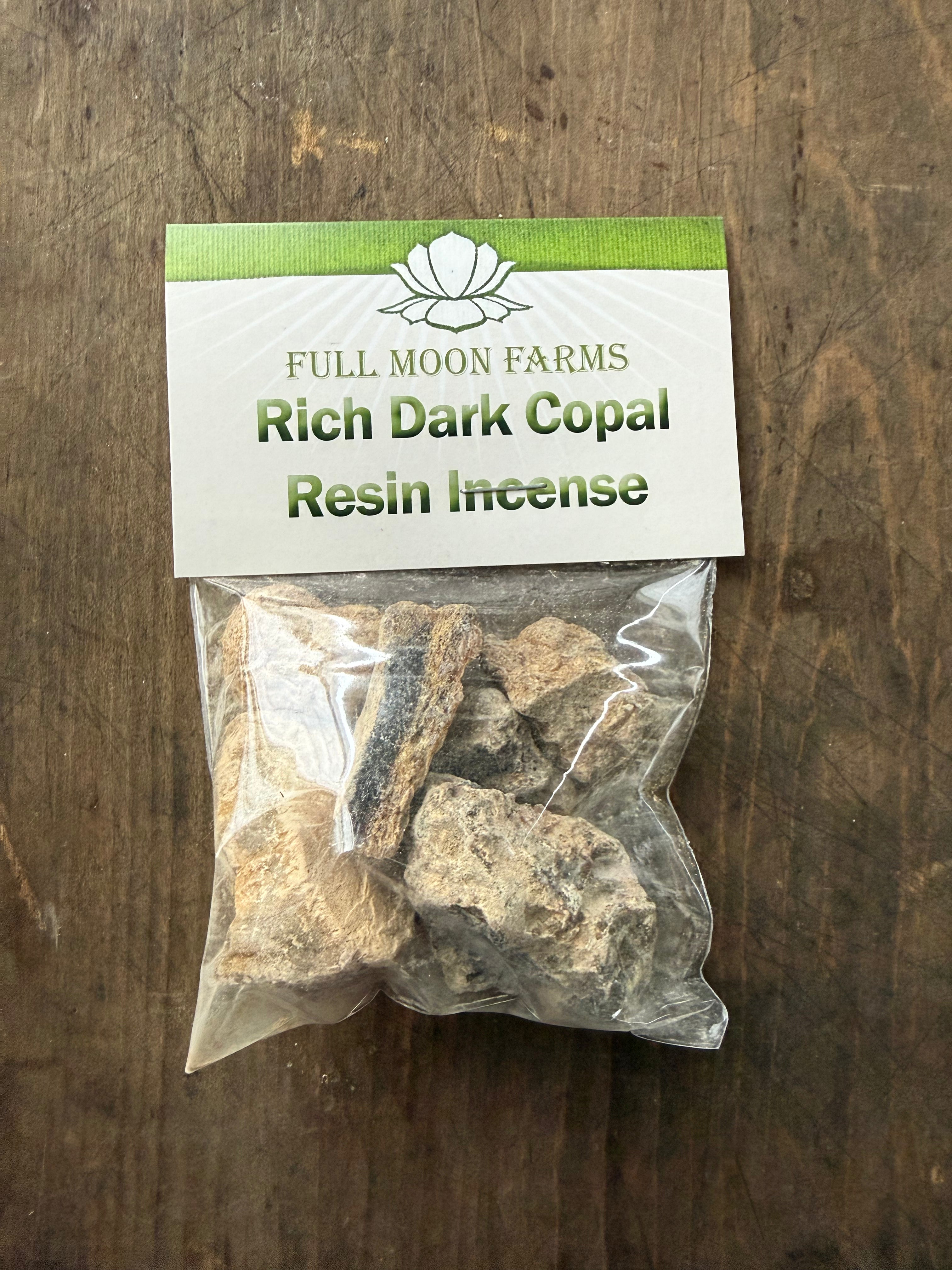 Packaged incense labeled 'Full Moon Farms Rich Dark Copal Resin Incense' on a wooden surface.