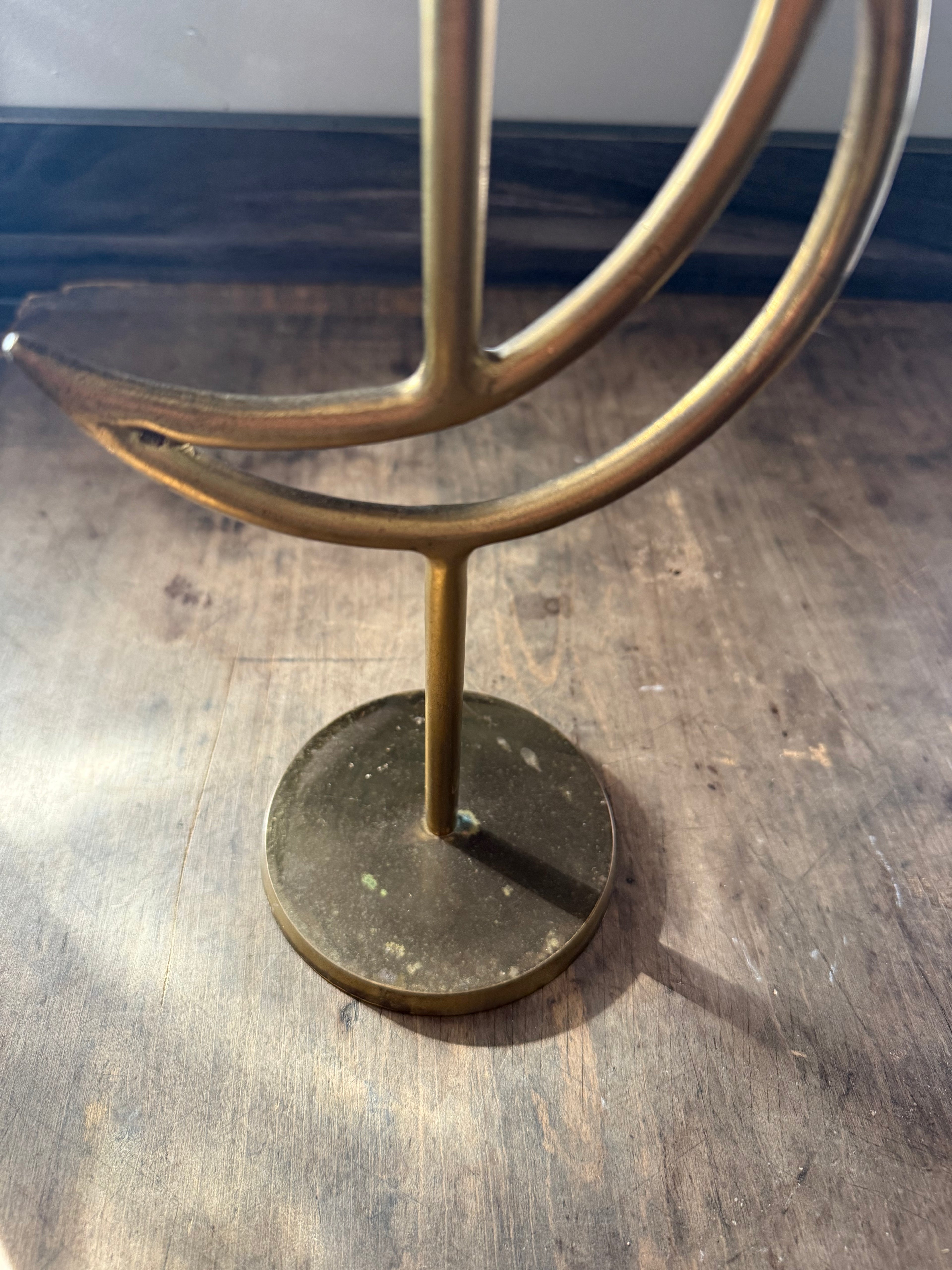 Brass decorative object on a wooden floor