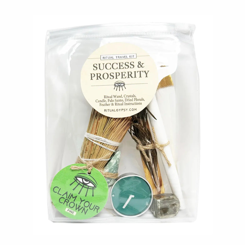 Packaged travel kit for success and prosperity with candles, sticks, and a label.