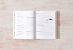 Open notebook on a wooden surface with celestial phase diagram