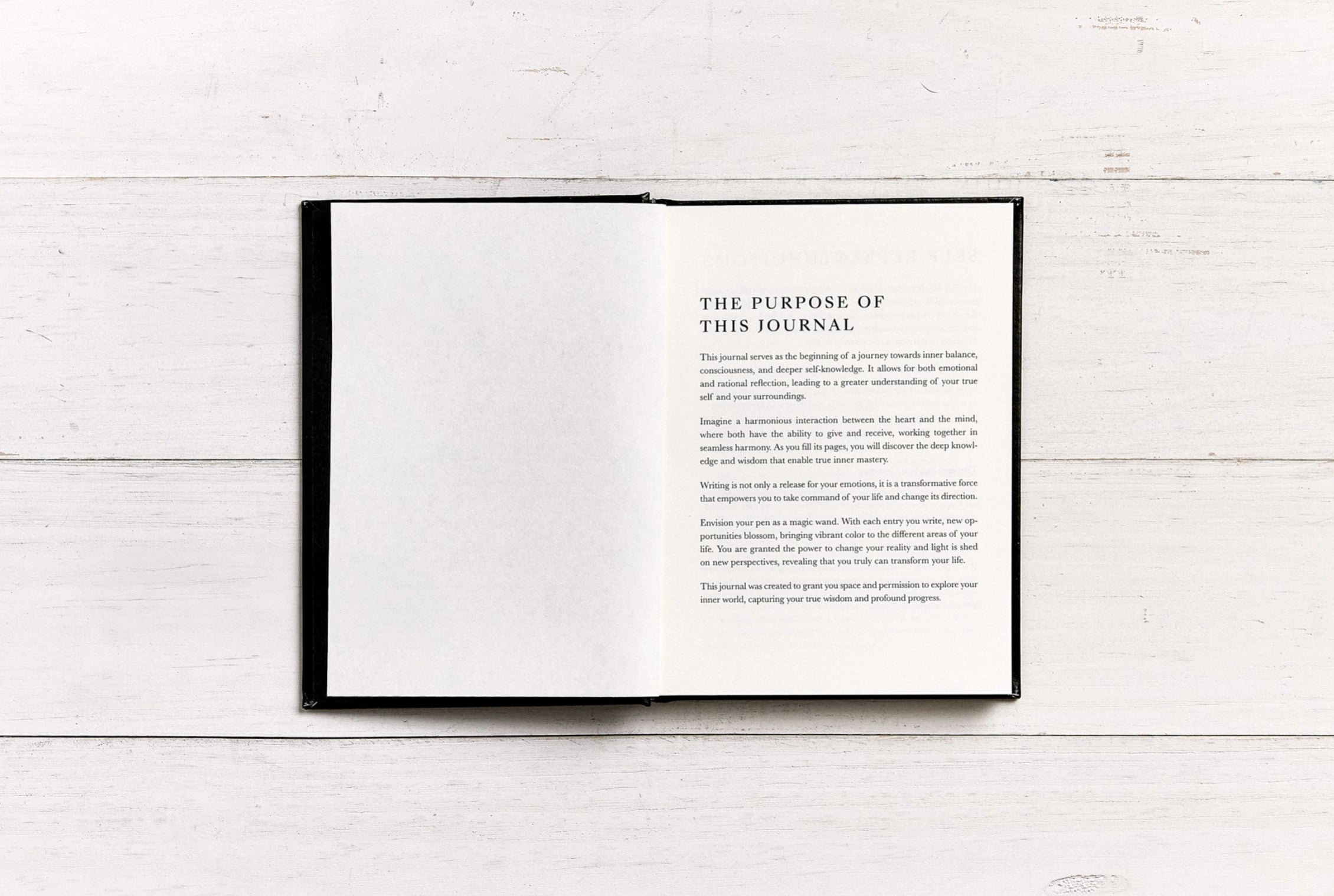Open book with text on a white wooden surface
