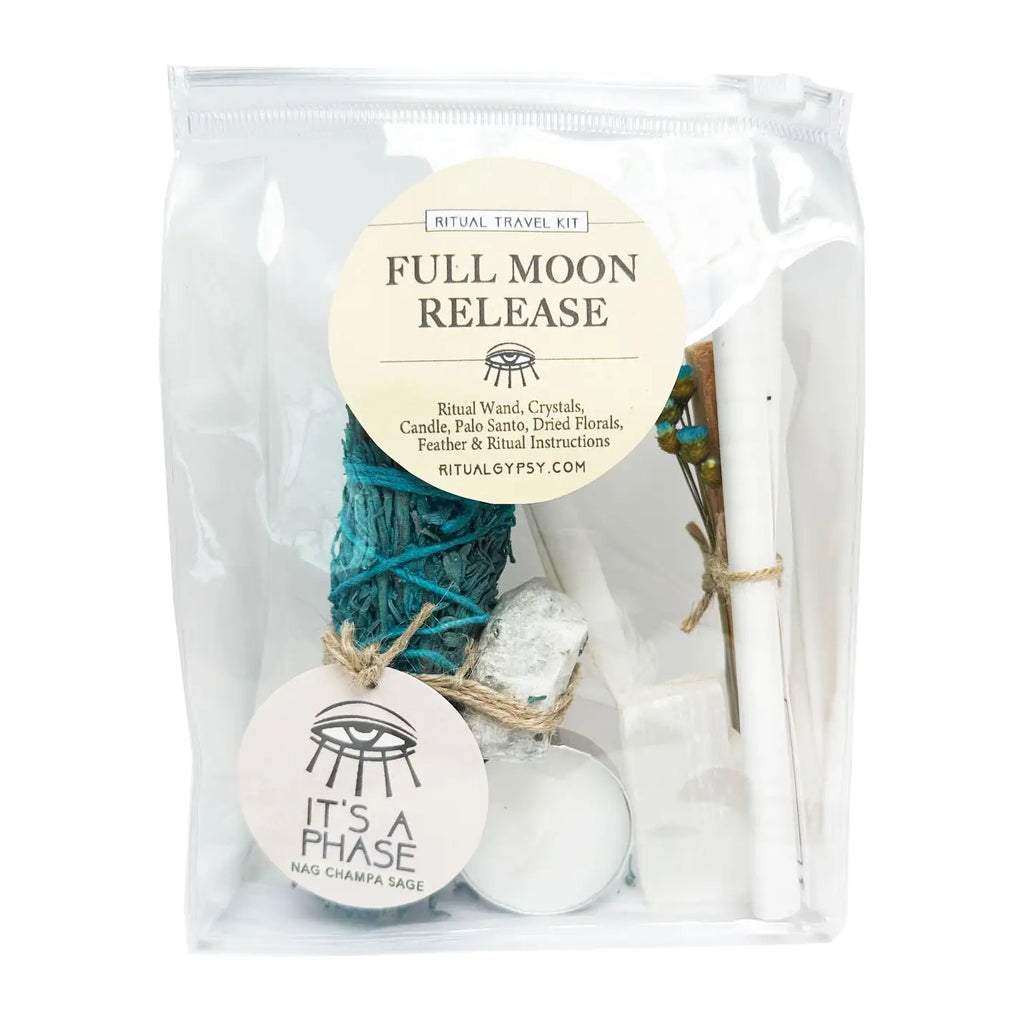 Ritual travel kit labeled 'Full Moon Release' with sage, crystals, and other items in a clear package.