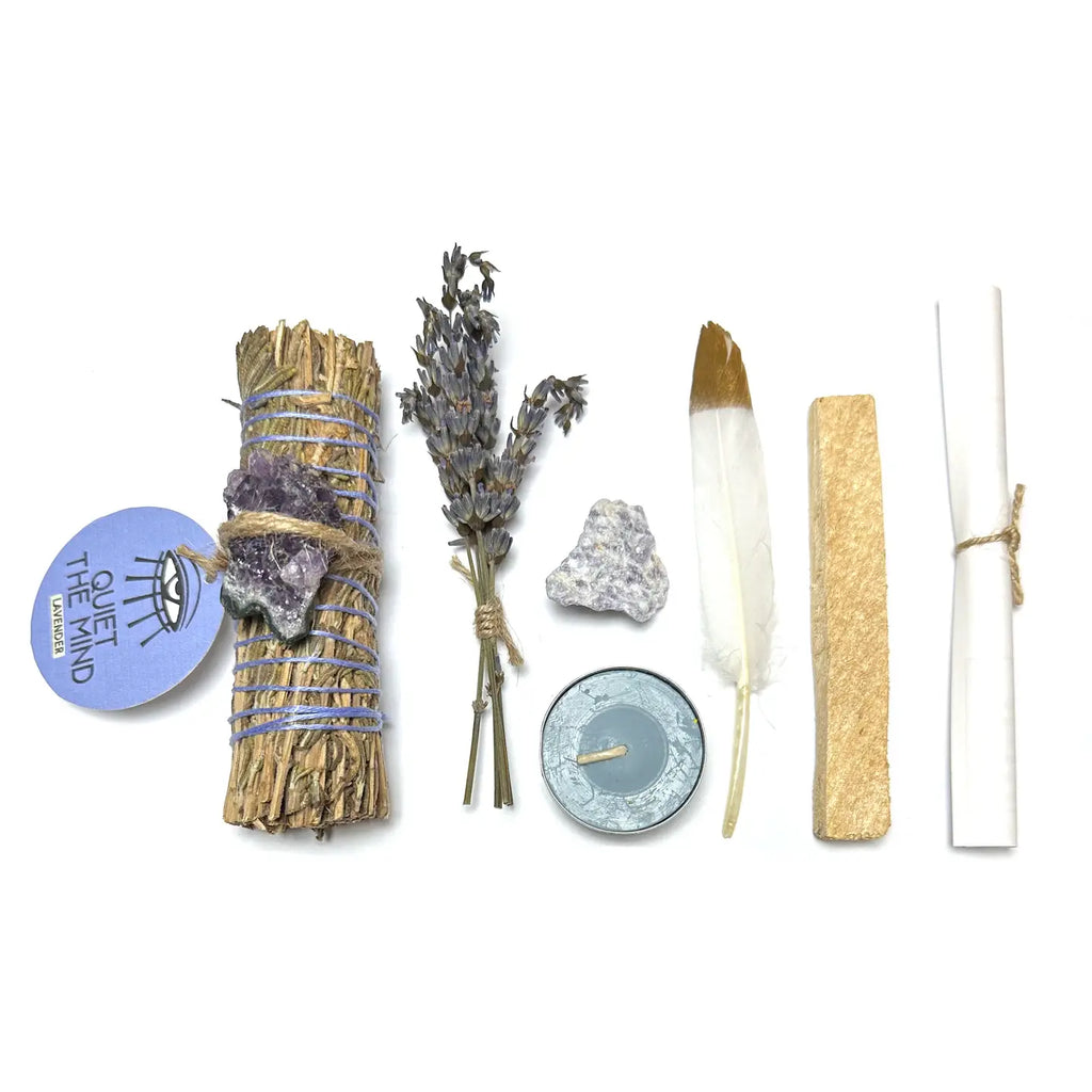 Collection of items including smudge sticks, lavender, a feather, and a candle on a white background.