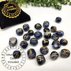 Set of blue stone runes with gold symbols on a white surface, accompanied by a black pouch labeled 'Rune Stones'.