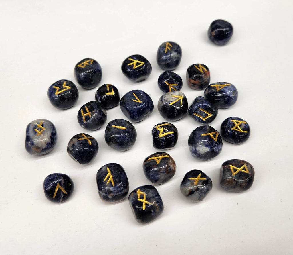 Set of black dice with gold symbols on a white background