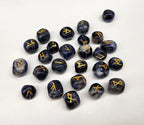 Set of black dice with gold symbols on a white background