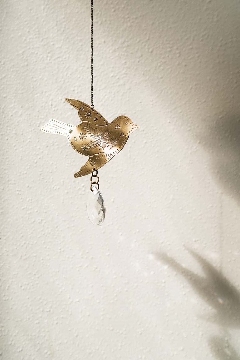 Surya Bird Engraved Brass Suncatcher — Floral Embossed Design with Teardrop Crystal