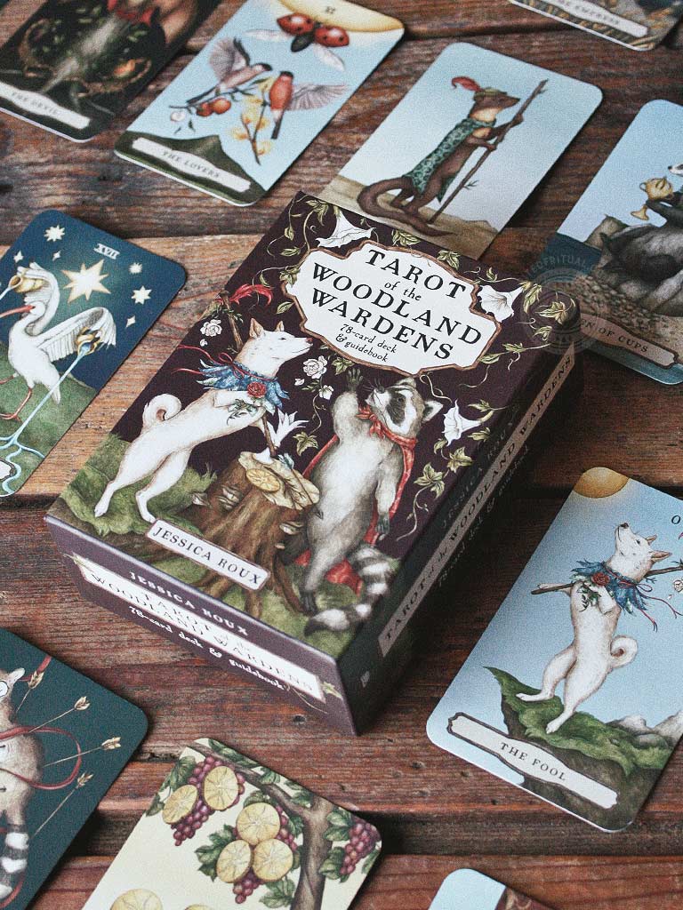 Tarot cards with animal illustrations on a wooden surface