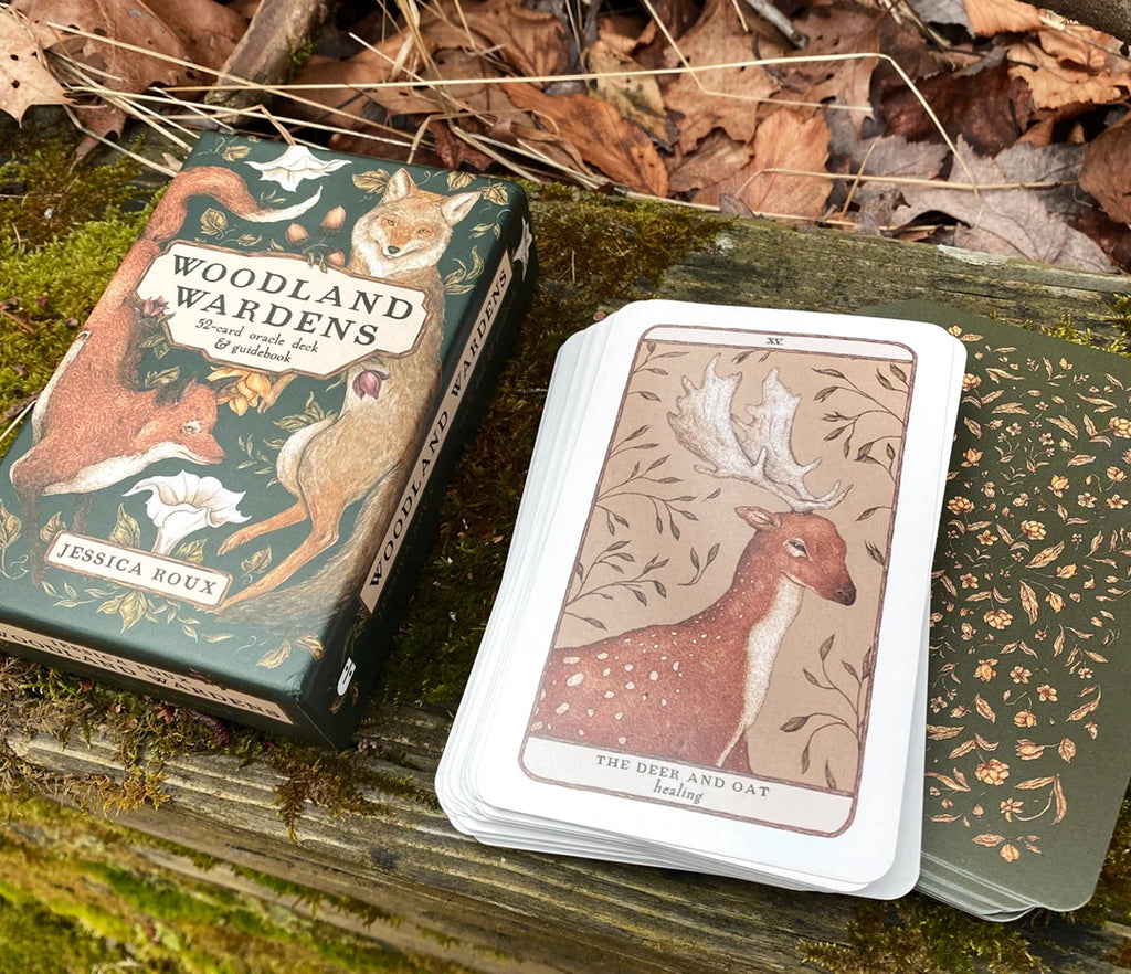 Woodland themed card game with cards and box on a wooden surface with leaves.