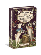A boxed tarot deck package titled "Tarot of the Woodland Wardens" by Jessica Roux, shown at a slight angle on a white background. The box features an illustrated woodland scene with a white fox, a badger, flowers, and green foliage on a dark purple background.